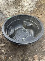 Full top-down view showing the round pond liner with its interior seating and textured base.