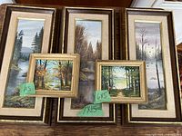 Five framed vintage landscape paintings showing various forest and lake scenes, two larger at 7x15 inches and three smaller at 6x5 inches.