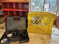 Weller Expert soldering tool in black case with solder wire, red metal organizer, yellow plastic crate with hardware