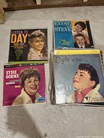 Four vintage vinyl record albums arranged on the floor showing front covers of Doris Day, Eydie Gorme, and Steve Lawrence