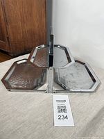 Front view of fully open bi-level chrome folding trays with hammered texture and octagonal shape.