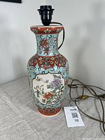 Front view of the large Famille Rose vase showing floral and butterfly decoration and lamp wiring.