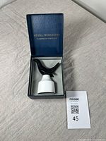 Royal Worcester bone china pie bird sitting in original blue box labeled 'Flameproof Porcelain'. Bird has black upper part and white base, glossy finish.