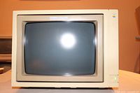 Front view of beige CRT monitor showing screen, power button and housing