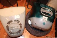 Overhead view of two vintage iMac G3 computers showing their distinctive rounded translucent cases in teal and white with Apple logos and cooling vents.