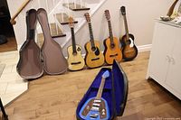 All guitars and two cases arranged on floor and stairs