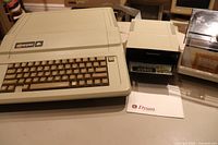 Apple IIe computer, Disk II drive, and disks in storage box