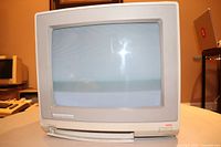 Front view of monitor powered on showing screen surface and housing condition