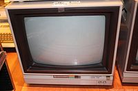 Front three-quarter view of beige Commodore 1702 CRT monitor with screen off