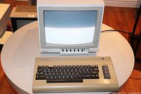 Overall view of keyboard in front of monitor on round table showing screen moiré
