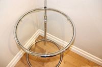 Top view showing clear round glass surface and chrome frame