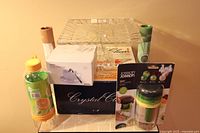 Full lot overview showing all items including cake plate, incense sticks with holders, Citrus Zinger, and spiralizer in packaging