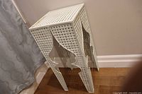 Front angle view of the cream-colored Moroccan style metal stand showing intricate cut-out pattern and overall structure.