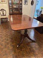 Full view of rectangular mahogany table top with polished wood surface in a dining room setting.
