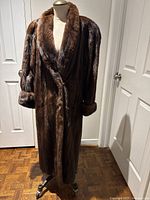 Front view of full-length mink coat on dress form