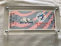 Close-up front view of acrylic-encased Toronto Blue Jays Opening Day ticket dated June 5, 1989, 7:35 PM, Skyclub Level