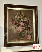 Frontal view of the antique framed needlework showing detailed floral embroidery and wooden frame with liner.