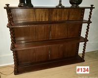 Front view of mahogany hanging shelf showing three shelves and twisted columns