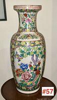 Full front view of the tall floor vase showing colorful floral and bird decorations.