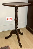 Full view of the Victorian mahogany candle stand showing round top, turned pedestal, and tripod base.