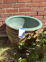 Front view showing raised dragon motif against brick background