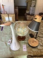 Overview of the two lamps and globe displayed together on a table, showcasing their size and condition.