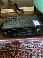 Front angle showing full receiver with ventilation grates and power cord on top.