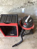 Porter Cable wet vacuum and foldable Insta Crate storage bin side by side on concrete floor