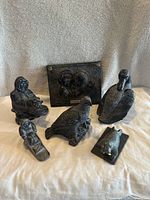 Grouped view of all six soapstone sculptures showing detailed textures and forms, confirming six distinct individual pieces.