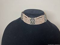 Front angle of the 6-strands faux pearl choker necklace showing the faux pearl strands and rhinestone ornaments