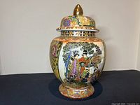 Front and side view of the vintage Chinese Satsuma style hand painted ceramic ginger jar showing colorful traditional figures and intricate gold details.