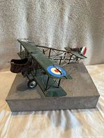 Front-left angled view showing painted details, cockpit and wing insignia