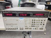 Front panel with three LED displays showing impedance magnitude, phase and frequency with keypad and function keys.