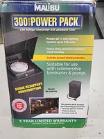 Front view of the boxed Malibu 300 Watt Power Pack showing key features and product details.