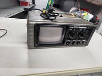 Front view of Panasonic portable TV/radio unit showing CRT screen and controls.