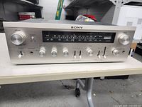 Front view of Sony STR-6050 FM stereo/AM-FM receiver showing tuning dial and control knobs.