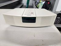 Front view of the white Bose Wave Radio showing digital display and overall condition.