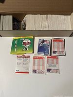 Spread of random selected 1990 Fleer baseball cards laid out, front and back visible. Cards include player photos, stats, baseball quizzes and team info.