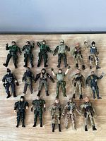 Lot of 17 Chap Me action soldier figures laid out on a wooden surface, showing various poses and uniforms.