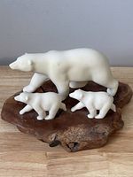 Full frontal view of the polar bear sculpture with two cubs on burlwood base showing general condition and size.