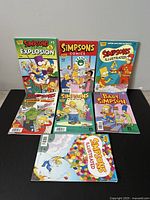 Front view of 7 Simpsons comic books arranged upright, showing colorful covers featuring characters like Bart Simpson and other Simpsons characters.