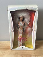 Front view of boxed doll showing full outfit and packaging