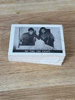 Stack of vintage Star Trek trading cards face up, showing black and white image featuring two characters in sci-fi attire with caption 'NO TIME FOR ESCAPE'
