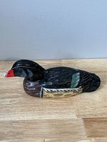 Side view of wood carved mallard duck decoy showing detailed paint and carving on wings and head