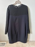 Back view of the Celine women's dress, showing sheer upper back and sleeves with an opaque main body, back zipper closure visible.