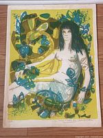 Full view of the surrealist-style print featuring a reclining female nude surrounded by abstract organic shapes in green, blue, and yellow.