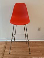 Front view of the entire stool showing seat shape and leg design