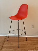 Three-quarter front view showing molded shell and chrome base