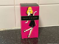 Front of Prada Candy perfume box showing stylish illustrated woman graphic and branding.
