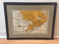 Framed vintage animated map of Ontario showing full map, inset, and wooden black frame.